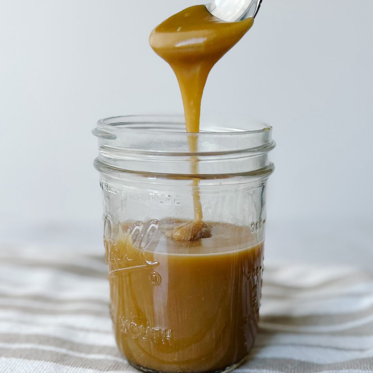 glass jar of homemade caramel sauce