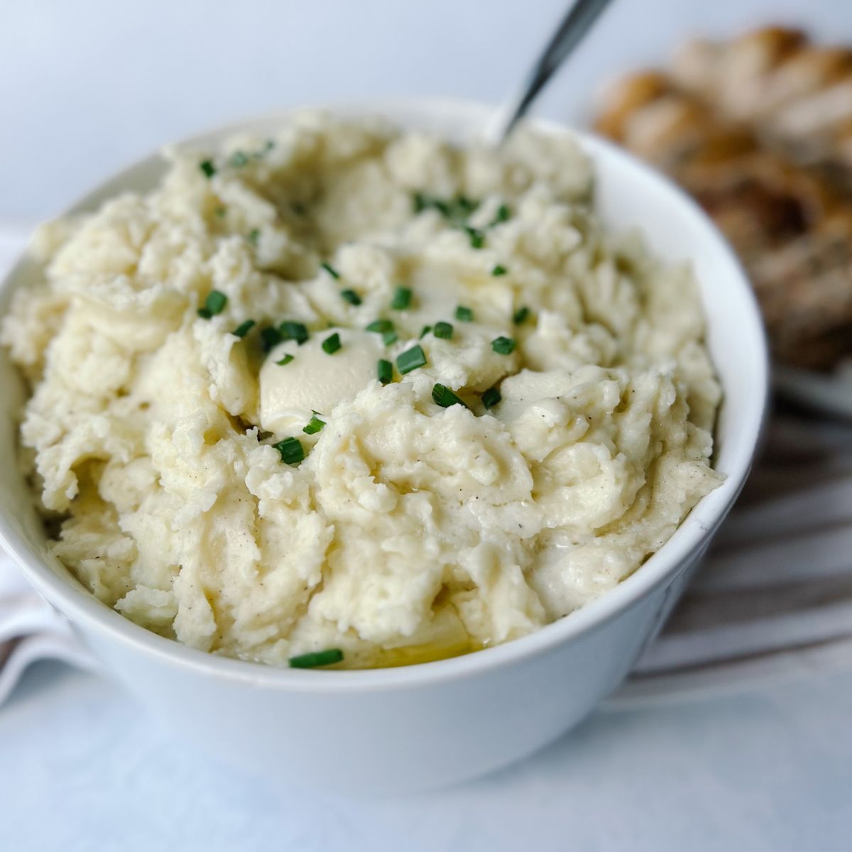 garlic mashed potatoes with chives on top.