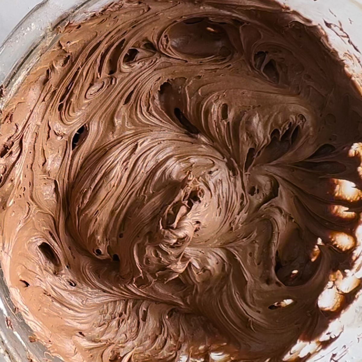 Completed chocolate cream cheese frosting in a mixing bowl. 
