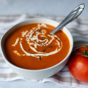 creamy tomato soup with heavy cream on top.