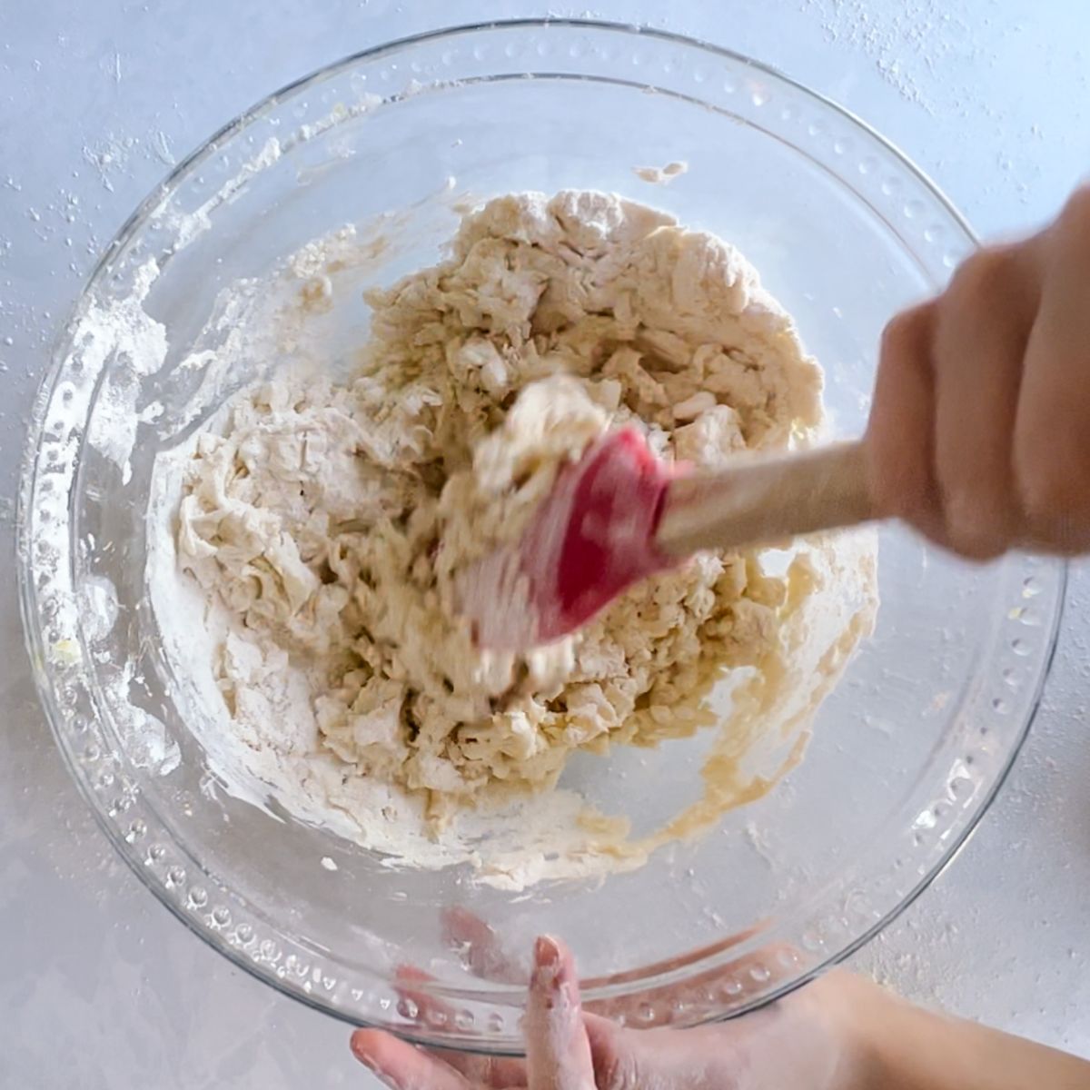 mixing the dough with a spatula.