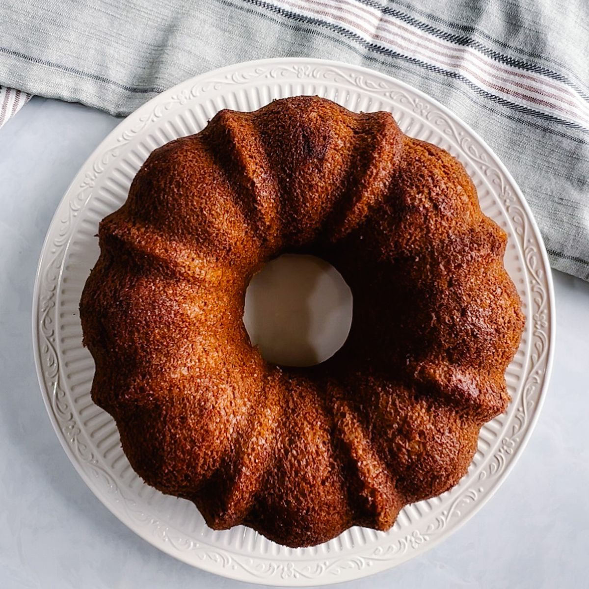 top shot of the bundt cake on a plate without frosting on it.