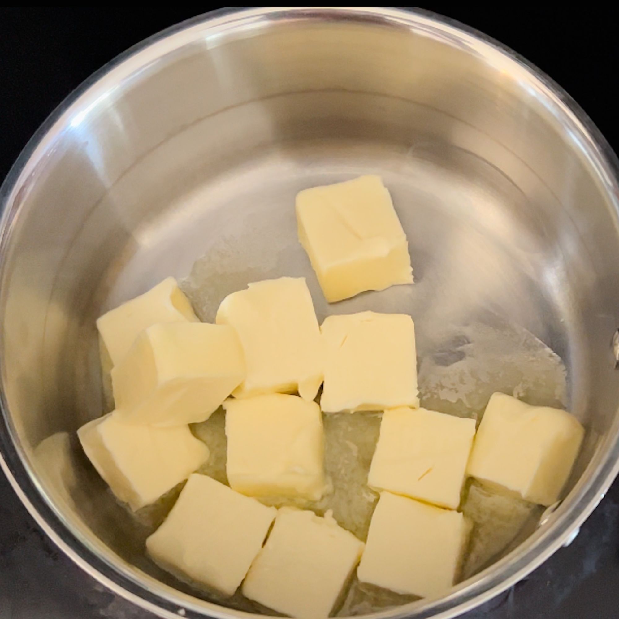 Cubed butter in a saucepan on the stove. 