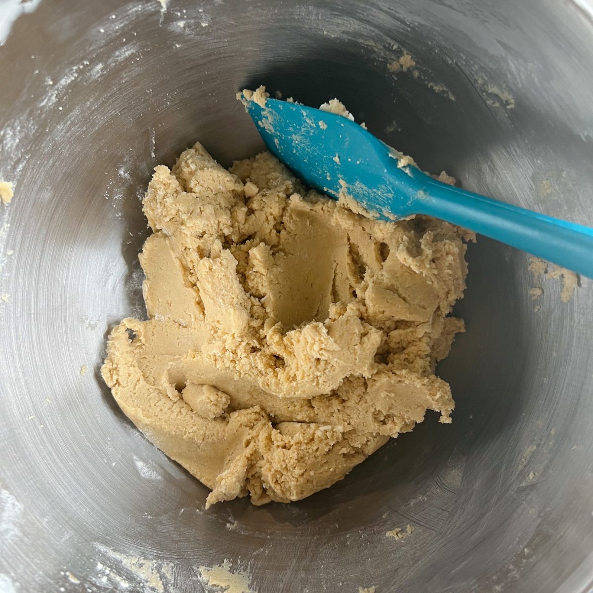 Cookie dough with the vanilla extract, baking soda, salt, and flour added to it.
