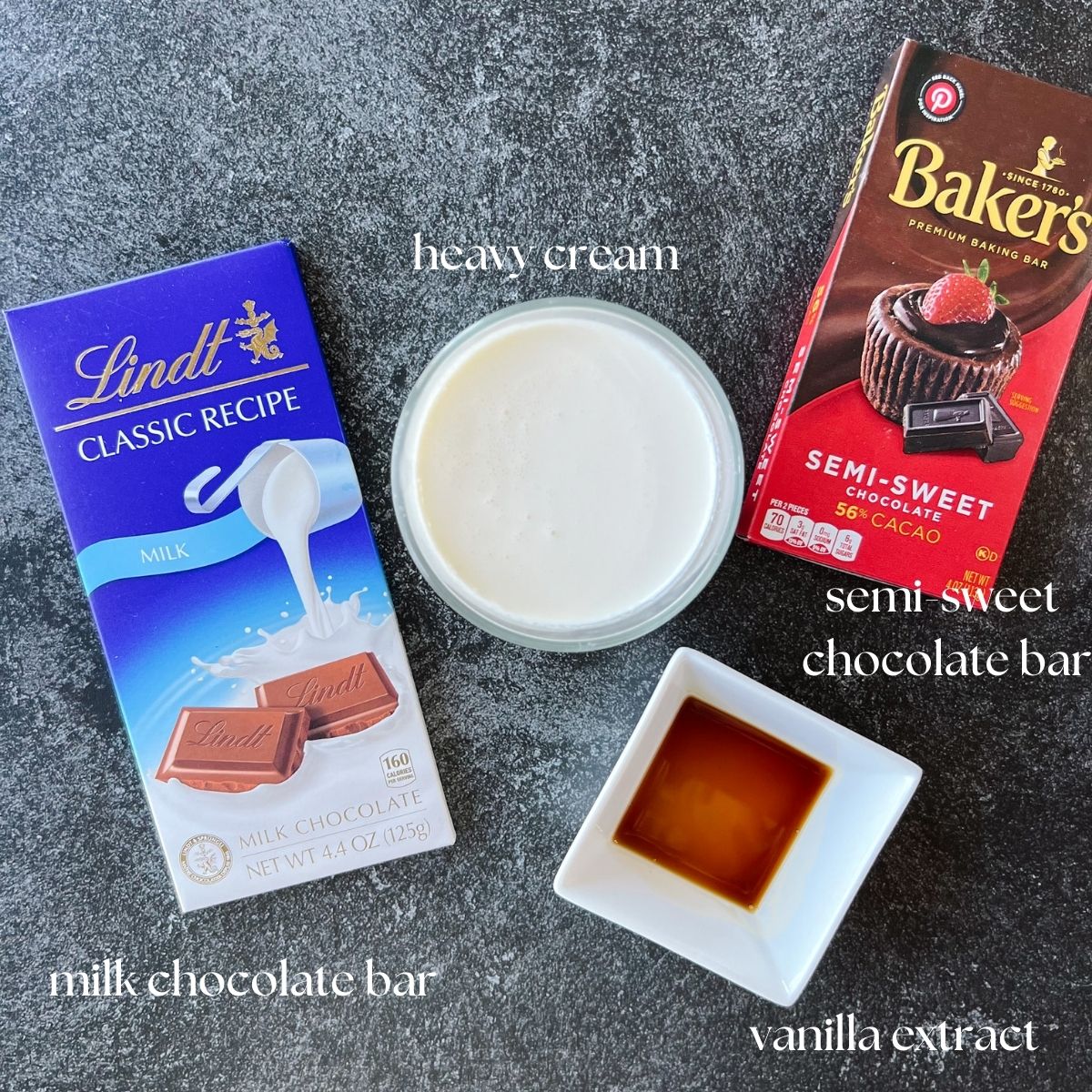 Ingredients shot for the ganache: semi-sweet chocolate bar, milk chocolate bar, heavy cream, and vanilla extract. 