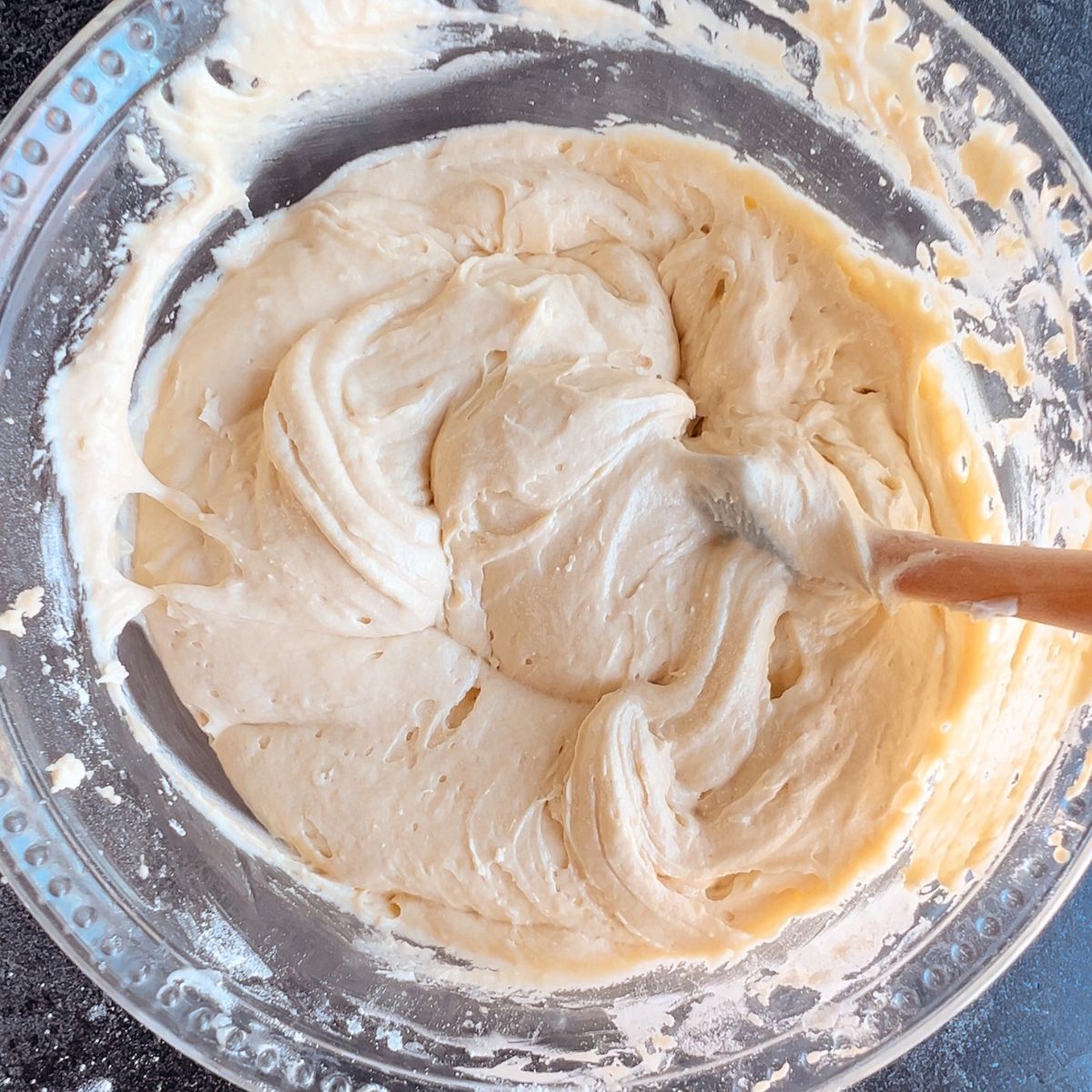 Almond coffee cake batter mixed together in a mixing bowl.
