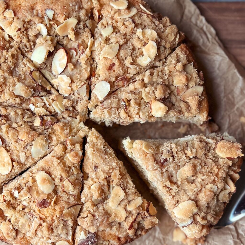 Closeup shot of almond coffee cake cut in eight slices.