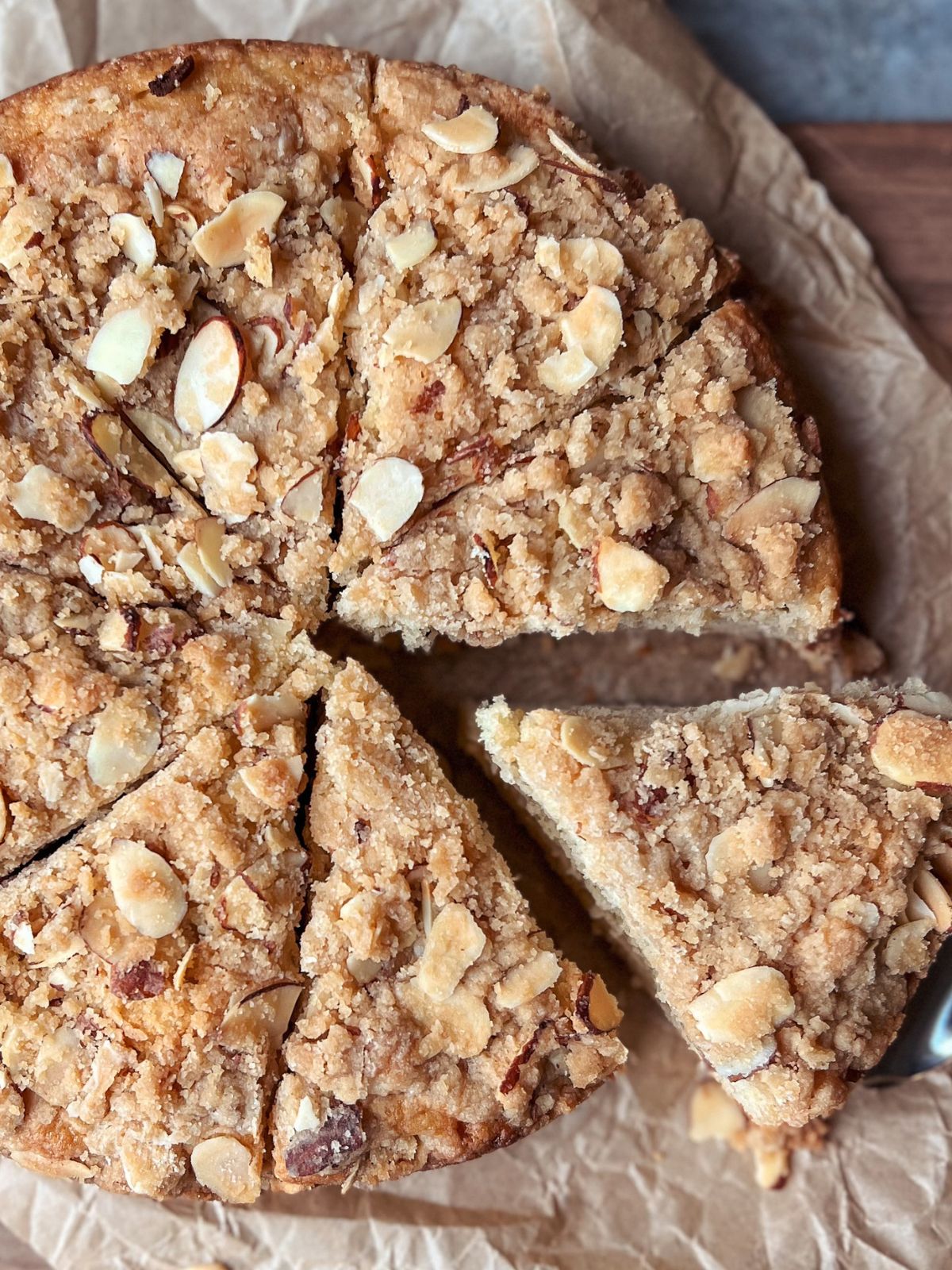 Closeup picture of almond coffee cake cut in eight slices.