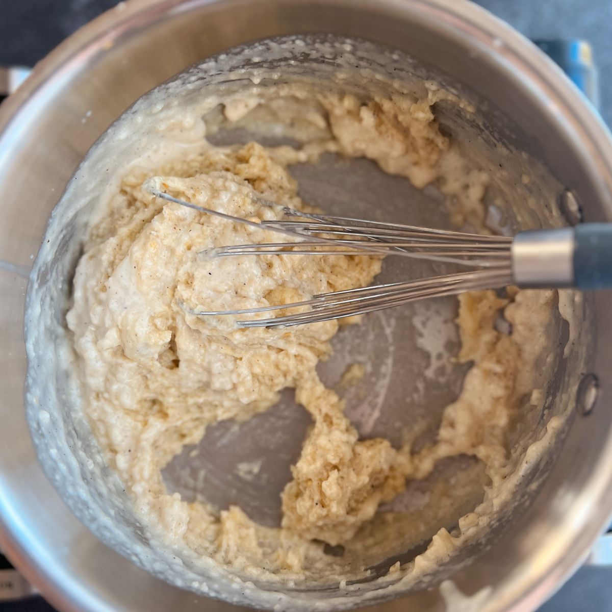 Saucepan on the stove with flour, butter, and seasonings whisked together to make a paste.