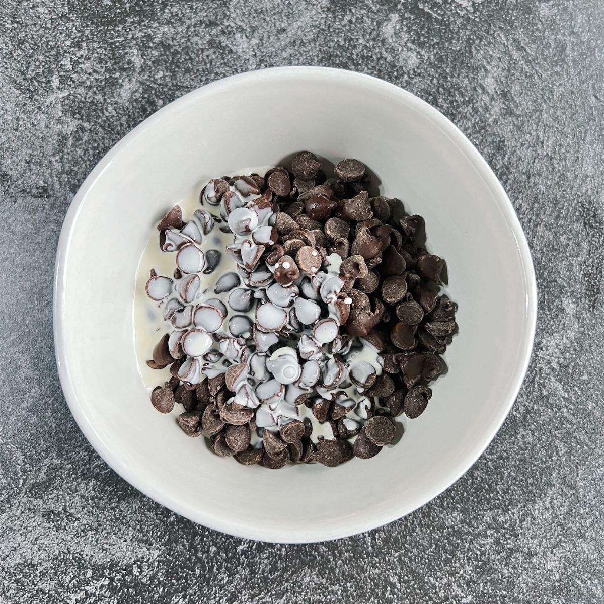 Chocolate chips and heavy cream in a bowl. 