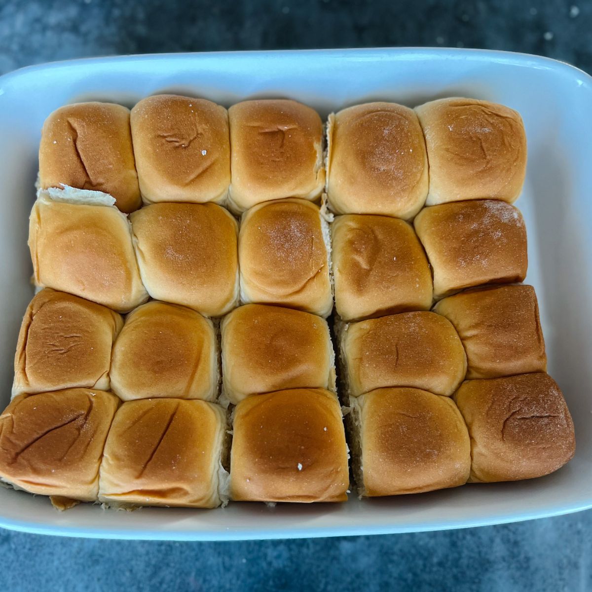 20 Hawaiian sweet rolls in a baking dish.
