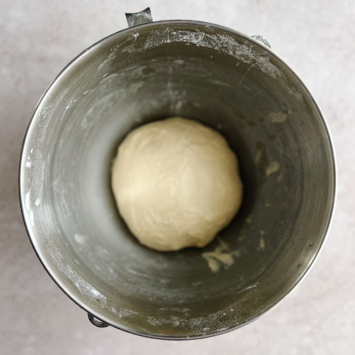 Kneaded ball of dough in a bowl ready to be covered and let rise.