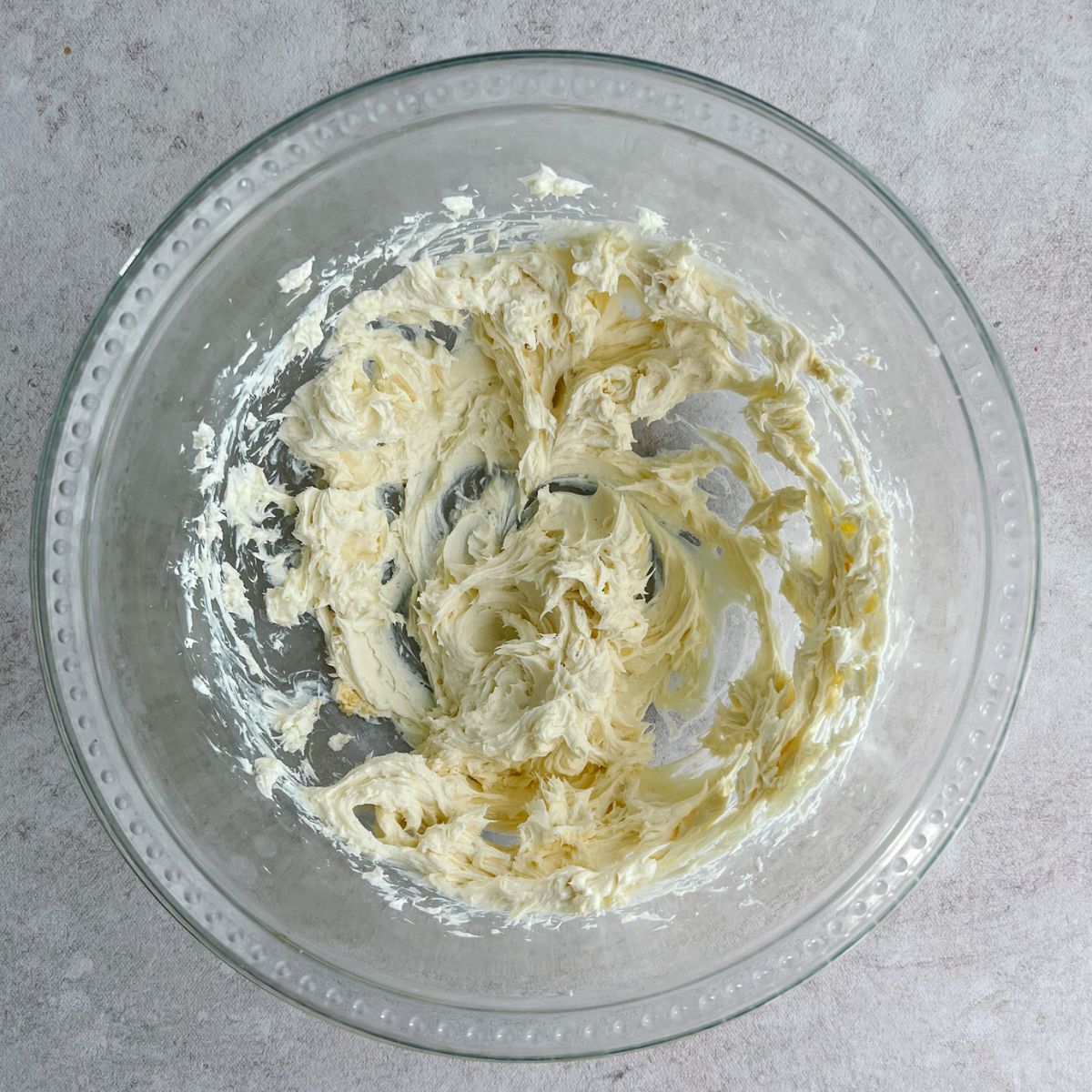 Mixing bowl with creamed cream cheese and butter.