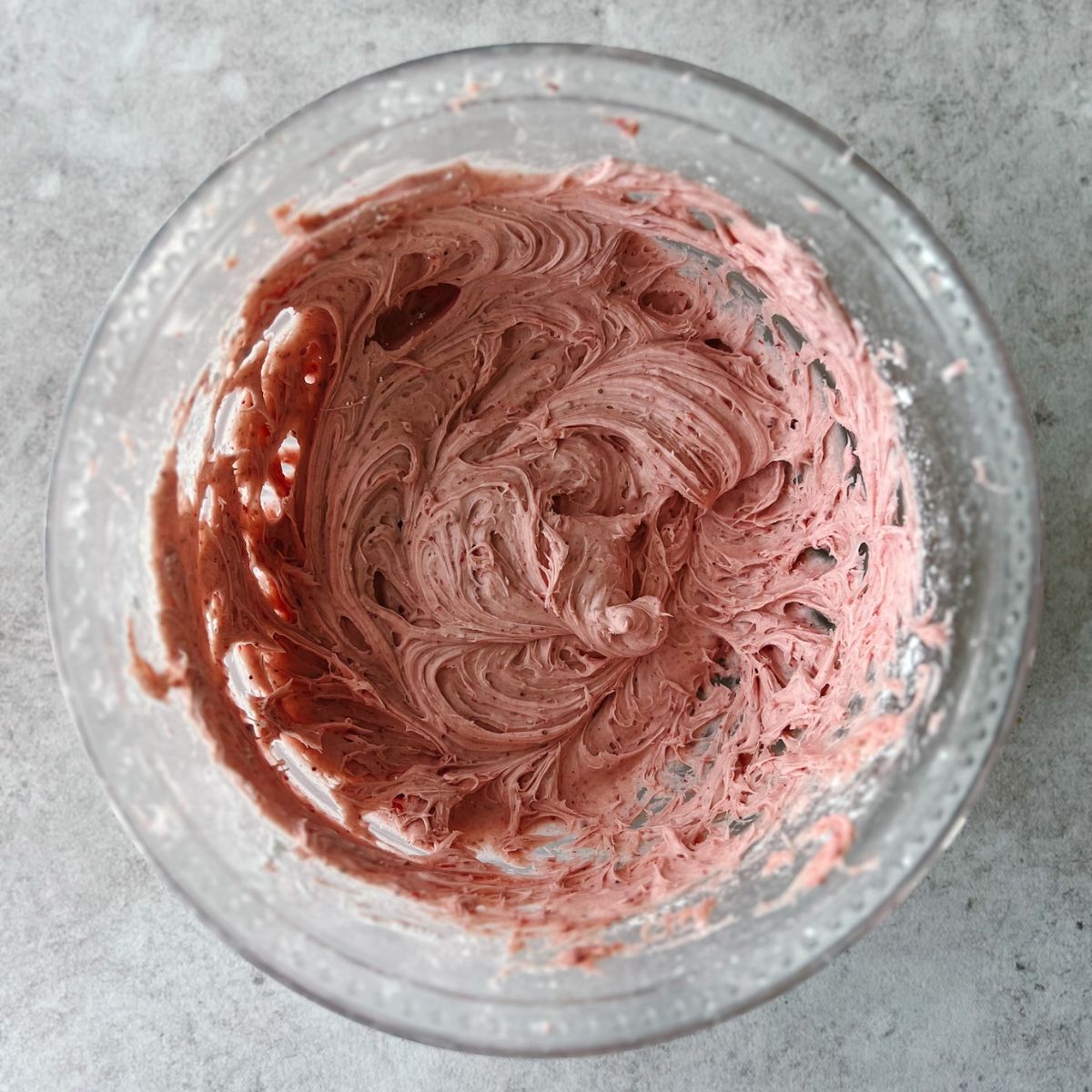 Strawberry cream cheese frosting in a mixing bowl.
