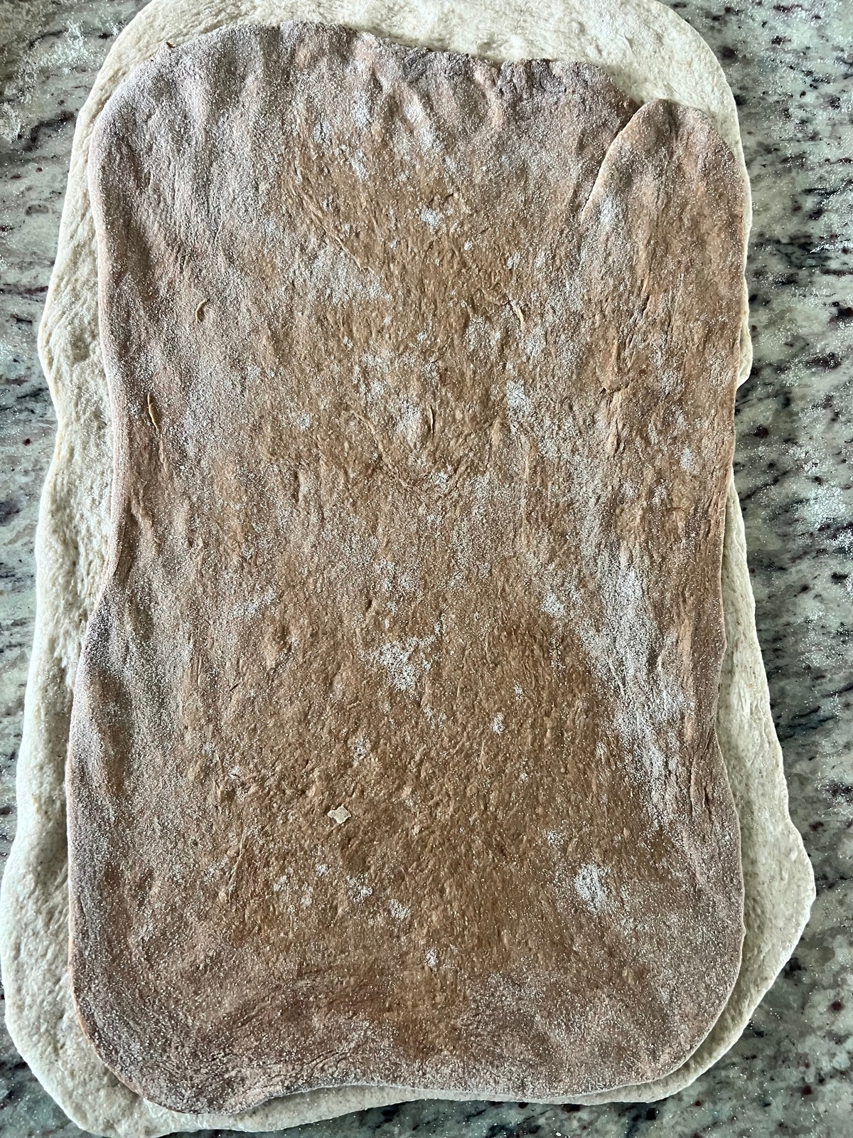 The dark dough rectangle is shown stacked over the lighter dough rectangle.