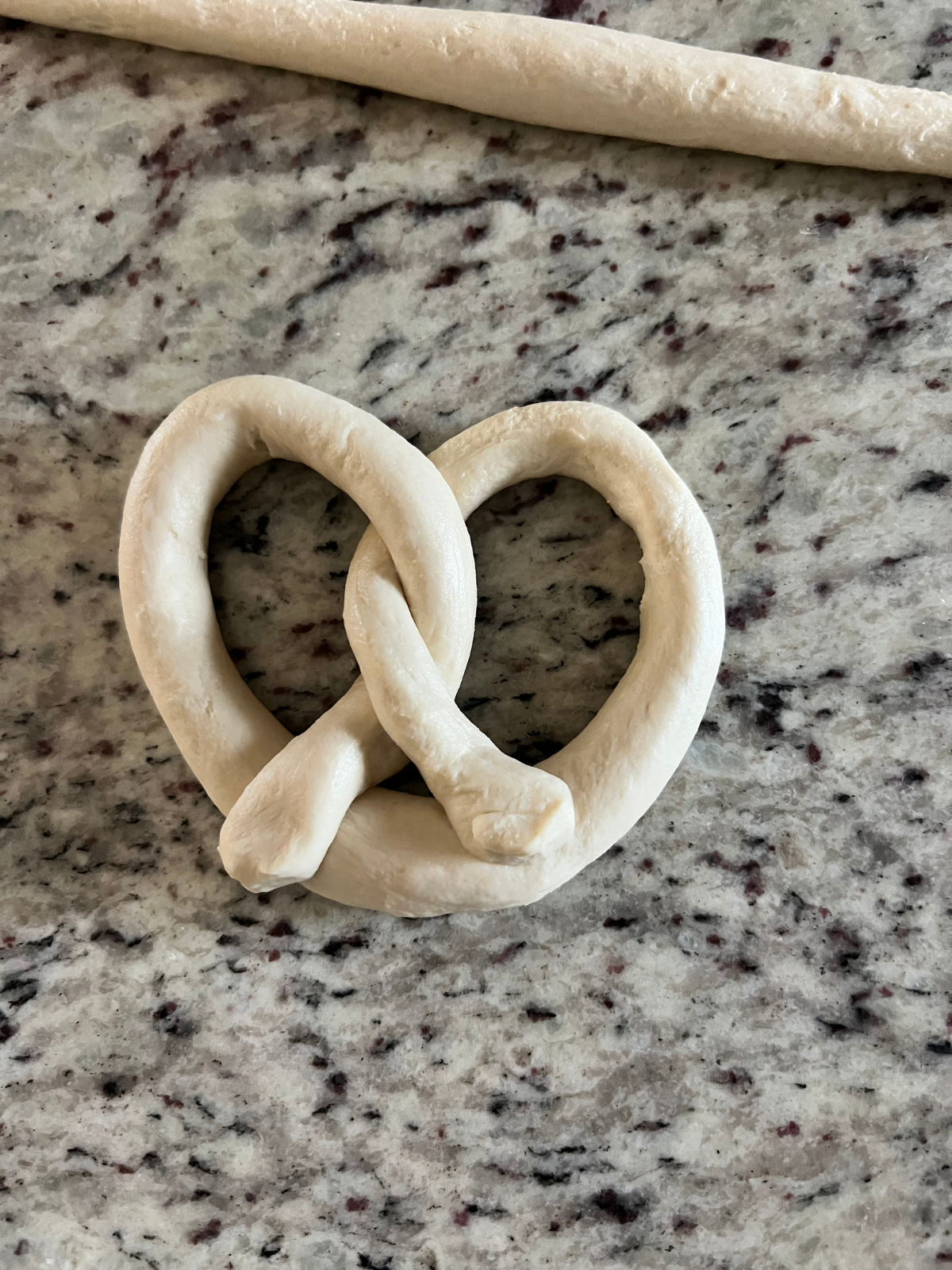 Shaped pretzel dough preparing for its second rise.