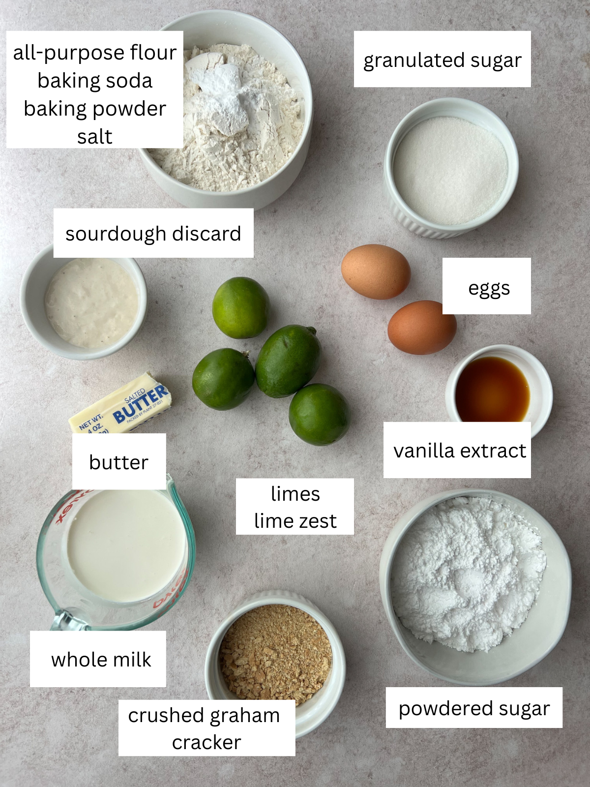 Ingredients for the key lime sourdough donuts: limes, all-purpose flour, baking powder, baking soda, salt, salted butter, granulated sugar, vanilla extract, 2 eggs, whole milk, sourdough discard, powdered sugar, milk, crushed graham crackers.