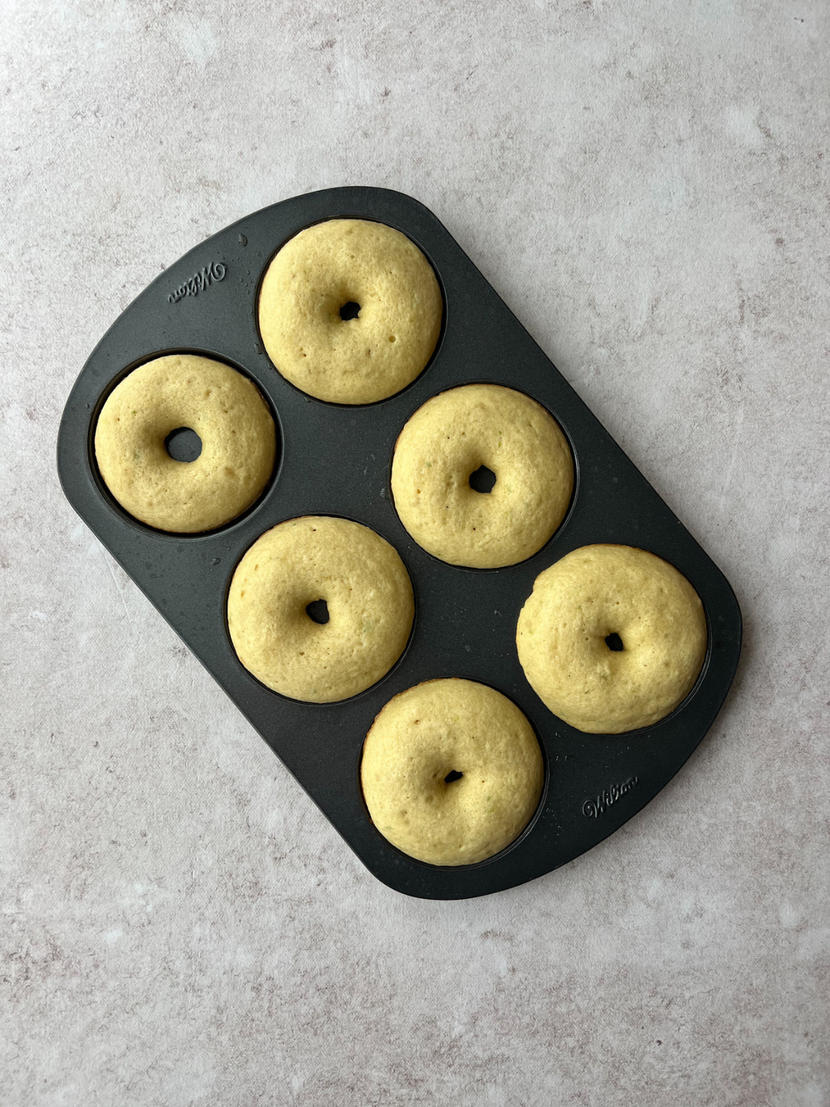 The donut pan with the baked key lime sourdough donuts.