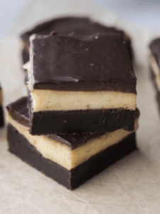 Two Boston cream brownies stacked with several in the background.