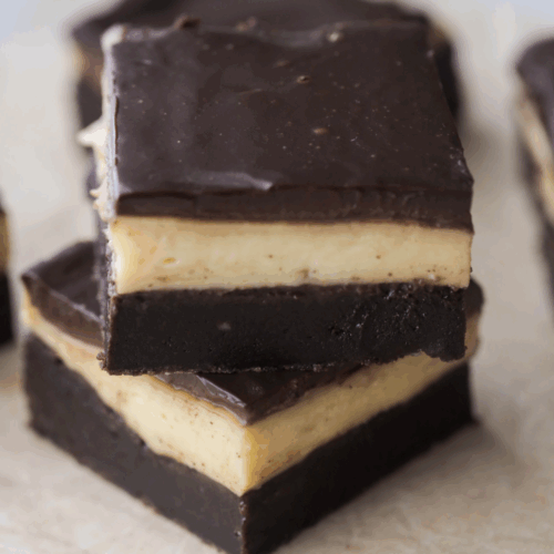 Two Boston cream brownies stacked with several in the background.