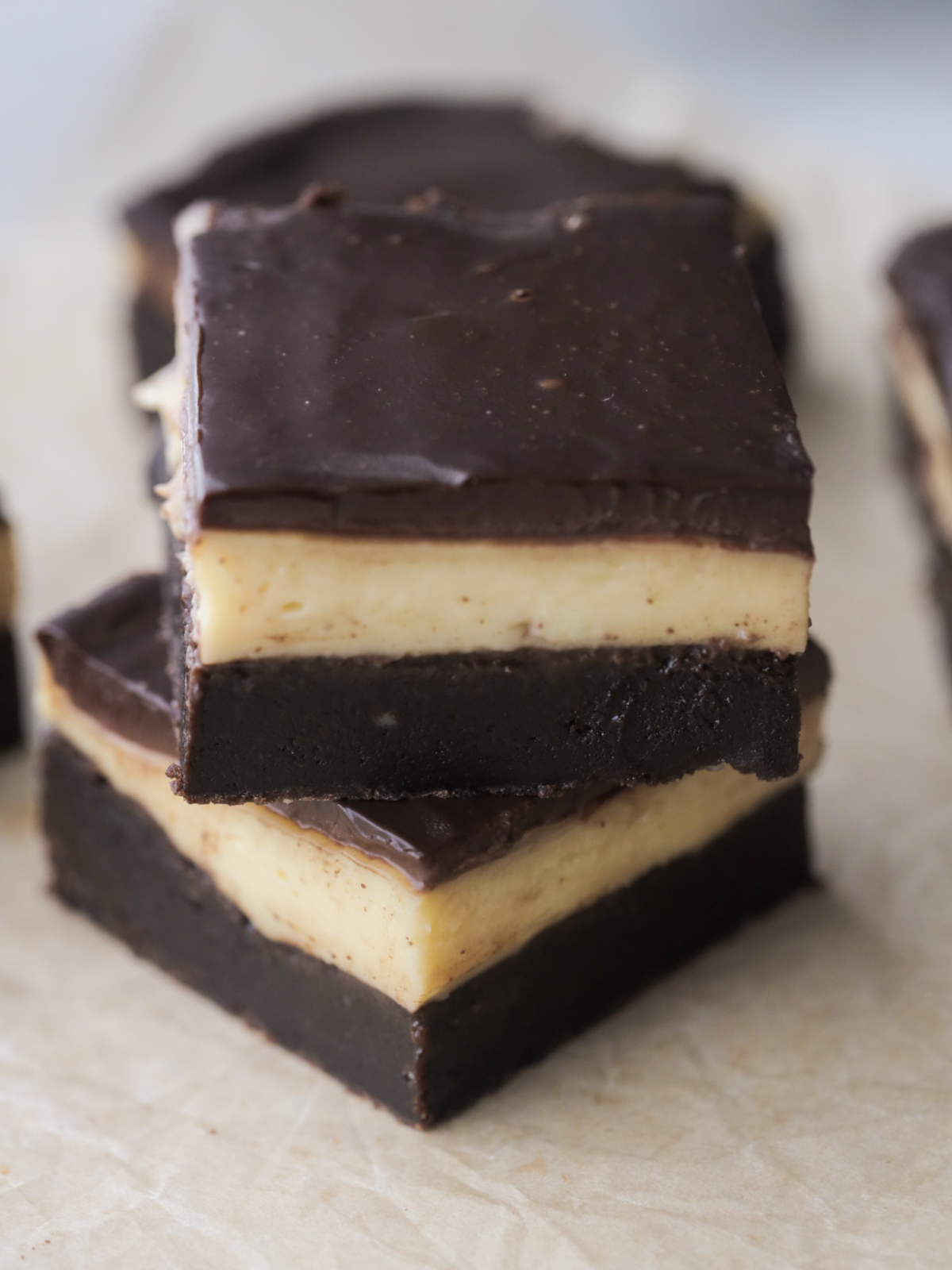 Two Boston cream brownies stacked with several in the background.