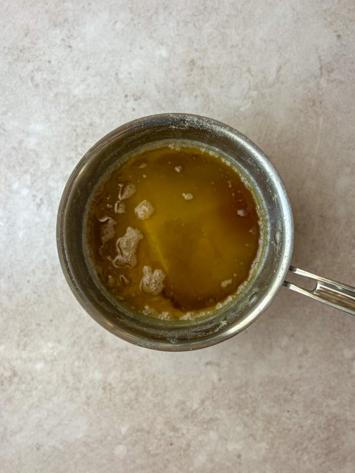 Browned butter sits in a saucepan.