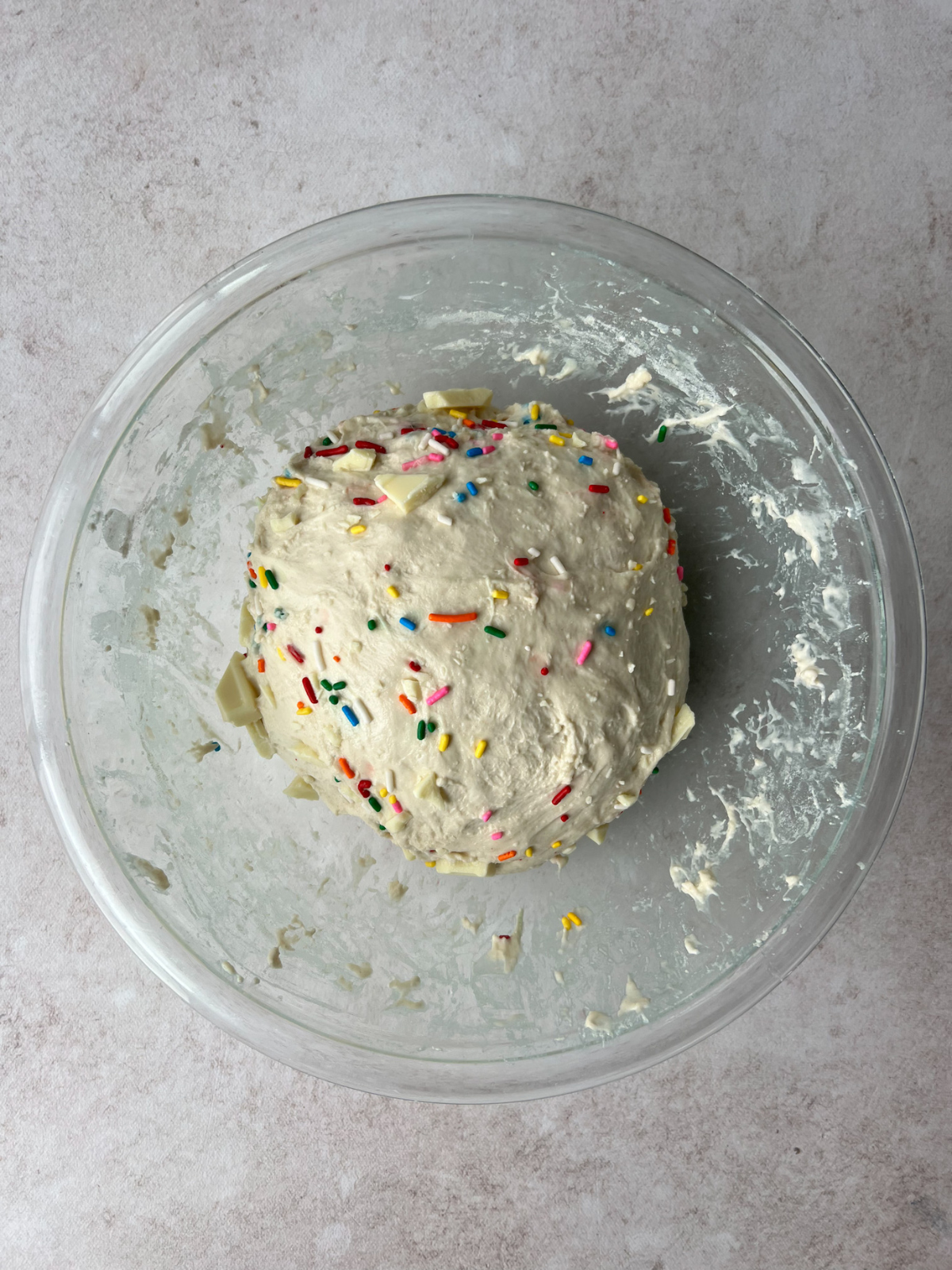 A dough ball with the sprinkles and white chocolate in the dough.