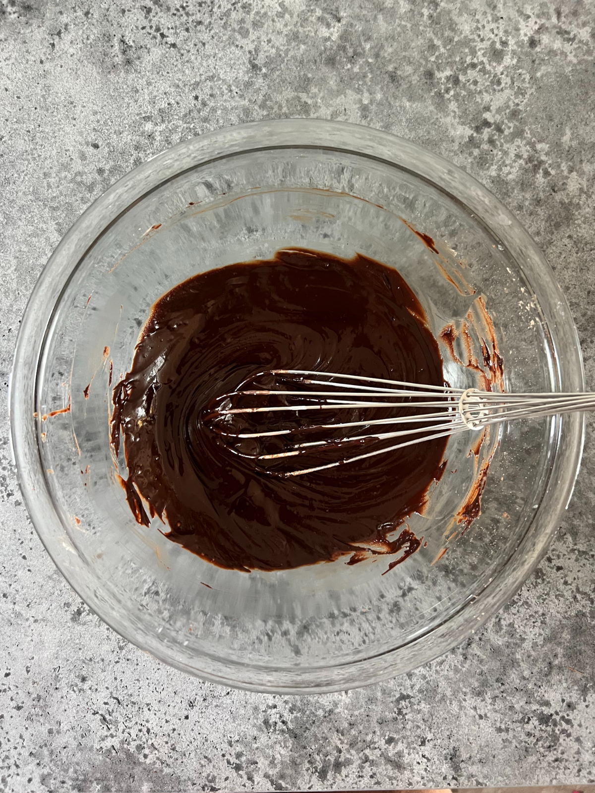The chocolate filling for the sourdough babka sits in a mixing bowl with a whisk in it.