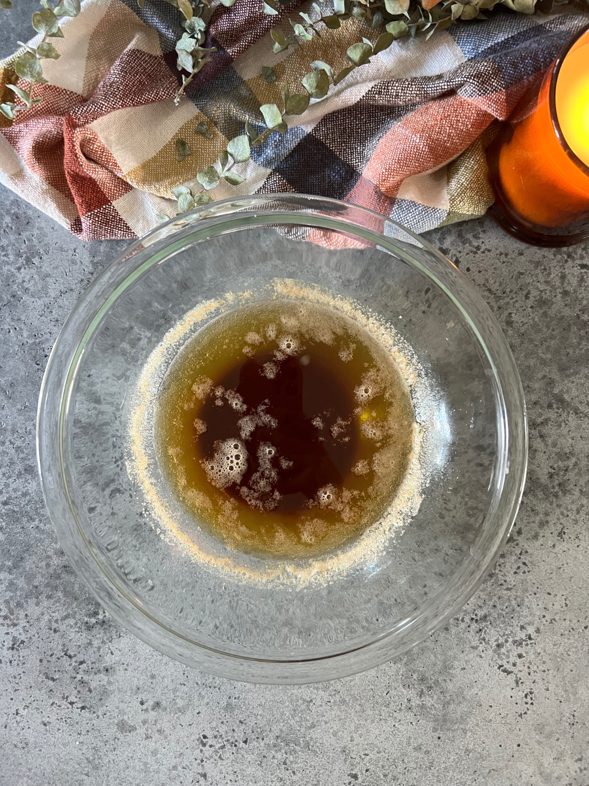 Browned butter sits in a glass mixing bowl.