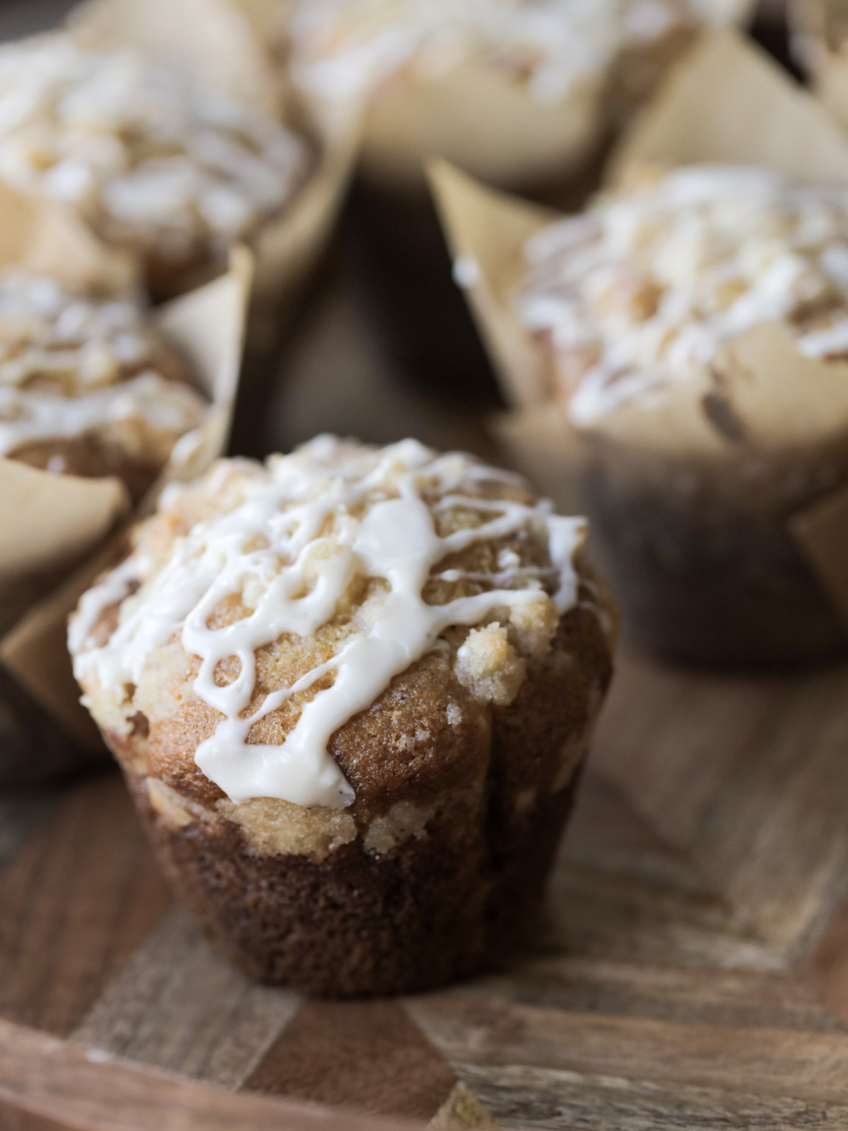 Another closeup of the vanilla bean sourdough discard muffins with the crumble topping and sweet vanilla bean icing. The liner is removed from this muffin.