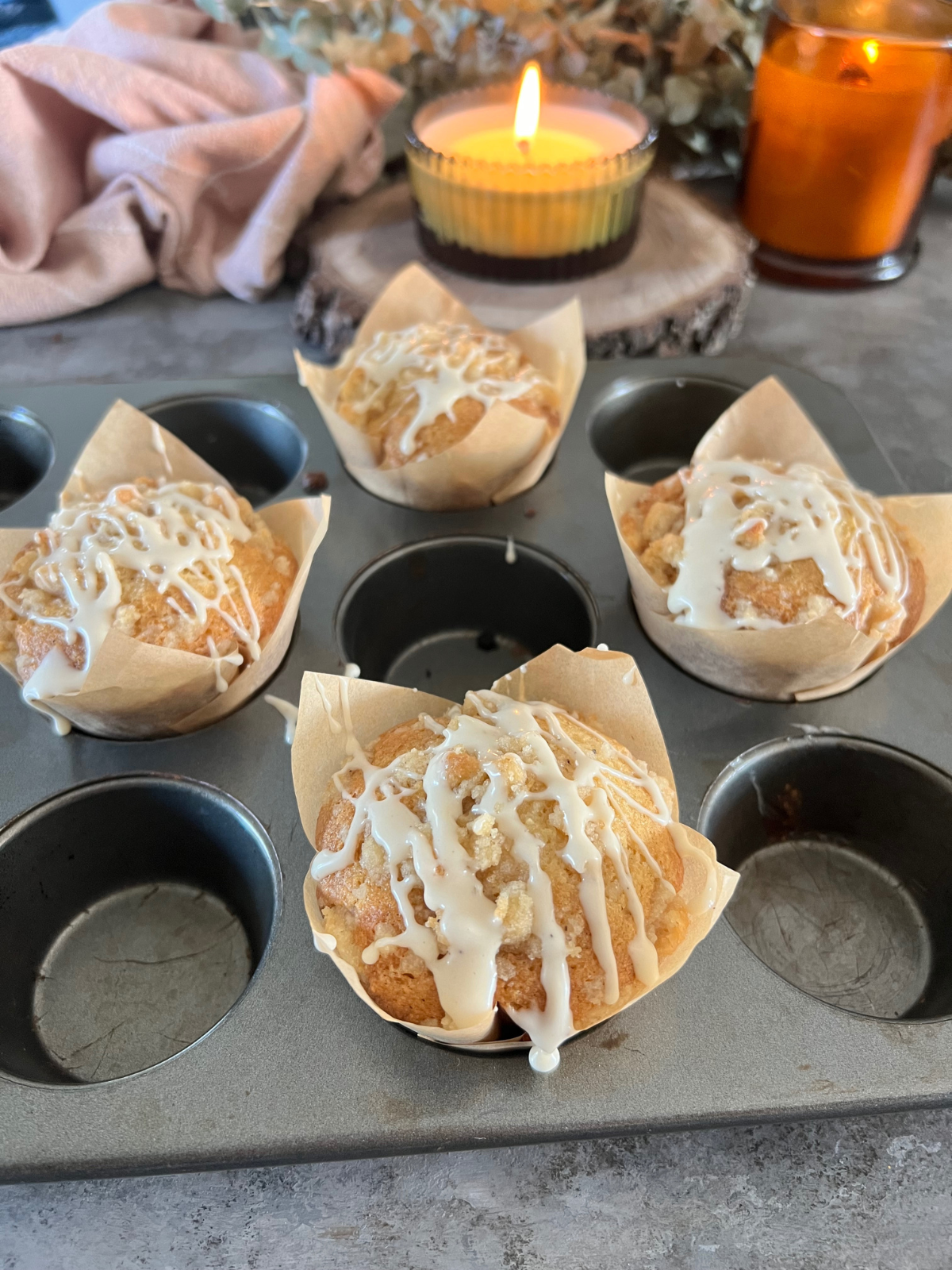The baked muffins have cooled and have been iced with the vanilla bean icing.