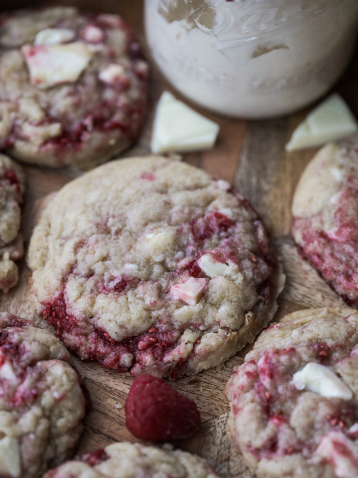Several sourdough raspberry white chocolate cookies on a tray. 