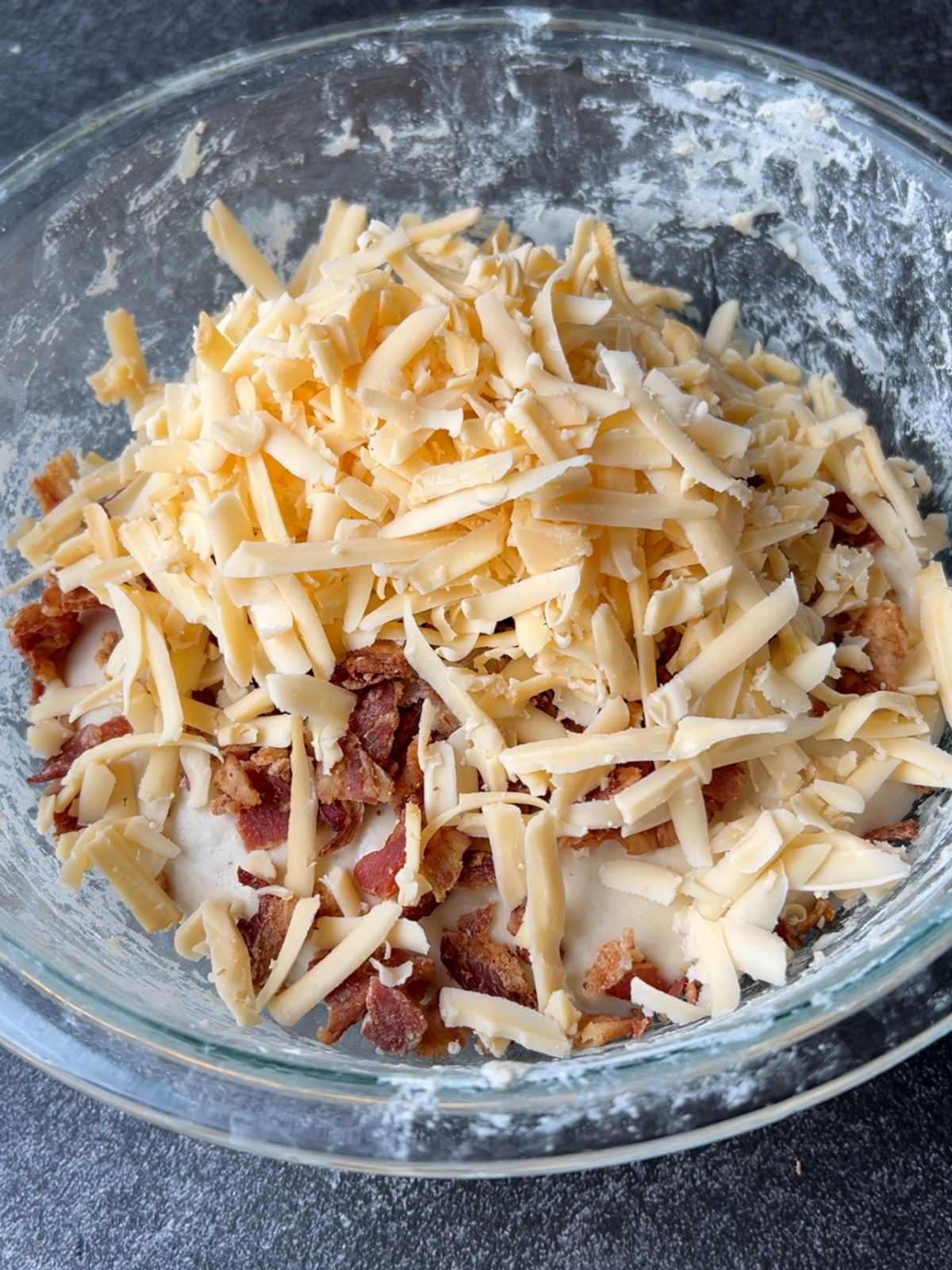 The shredded smoked gouda cheese has been added to the sourdough dough and chopped bacon.