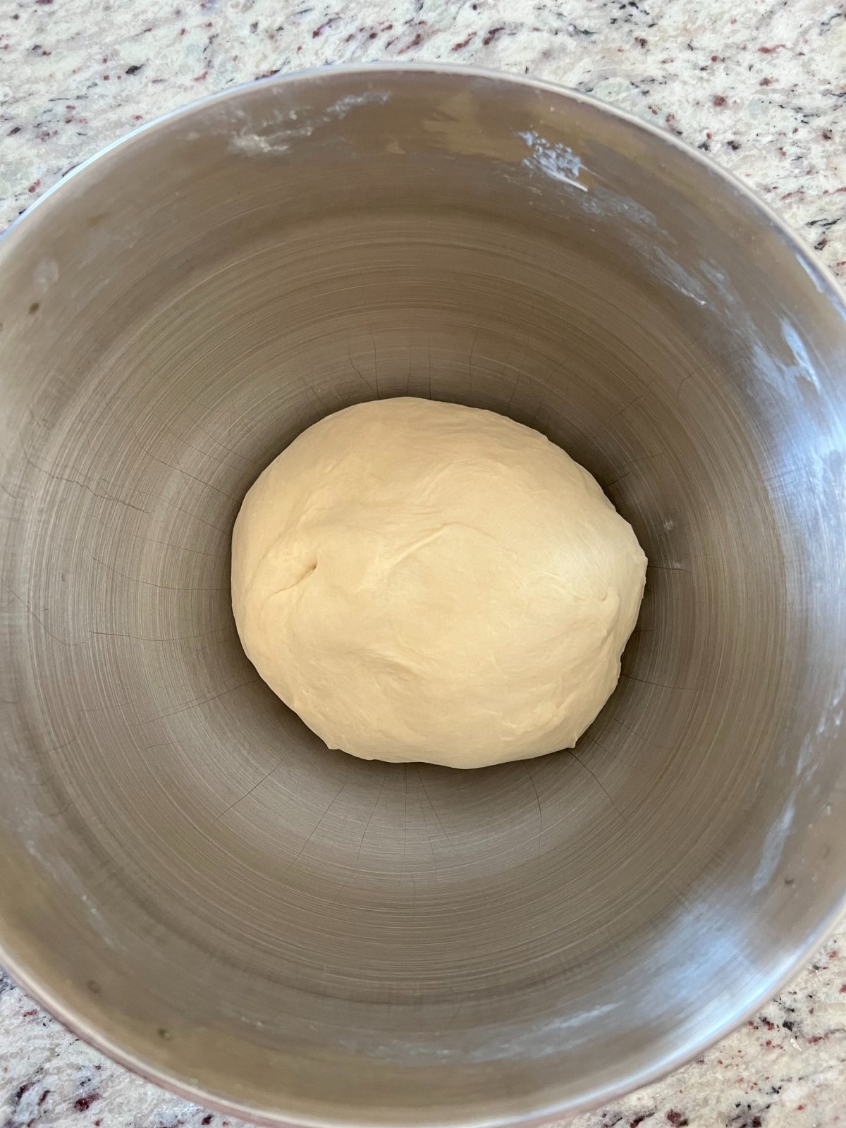 The mixing bowl holds the dough before it has risen. 