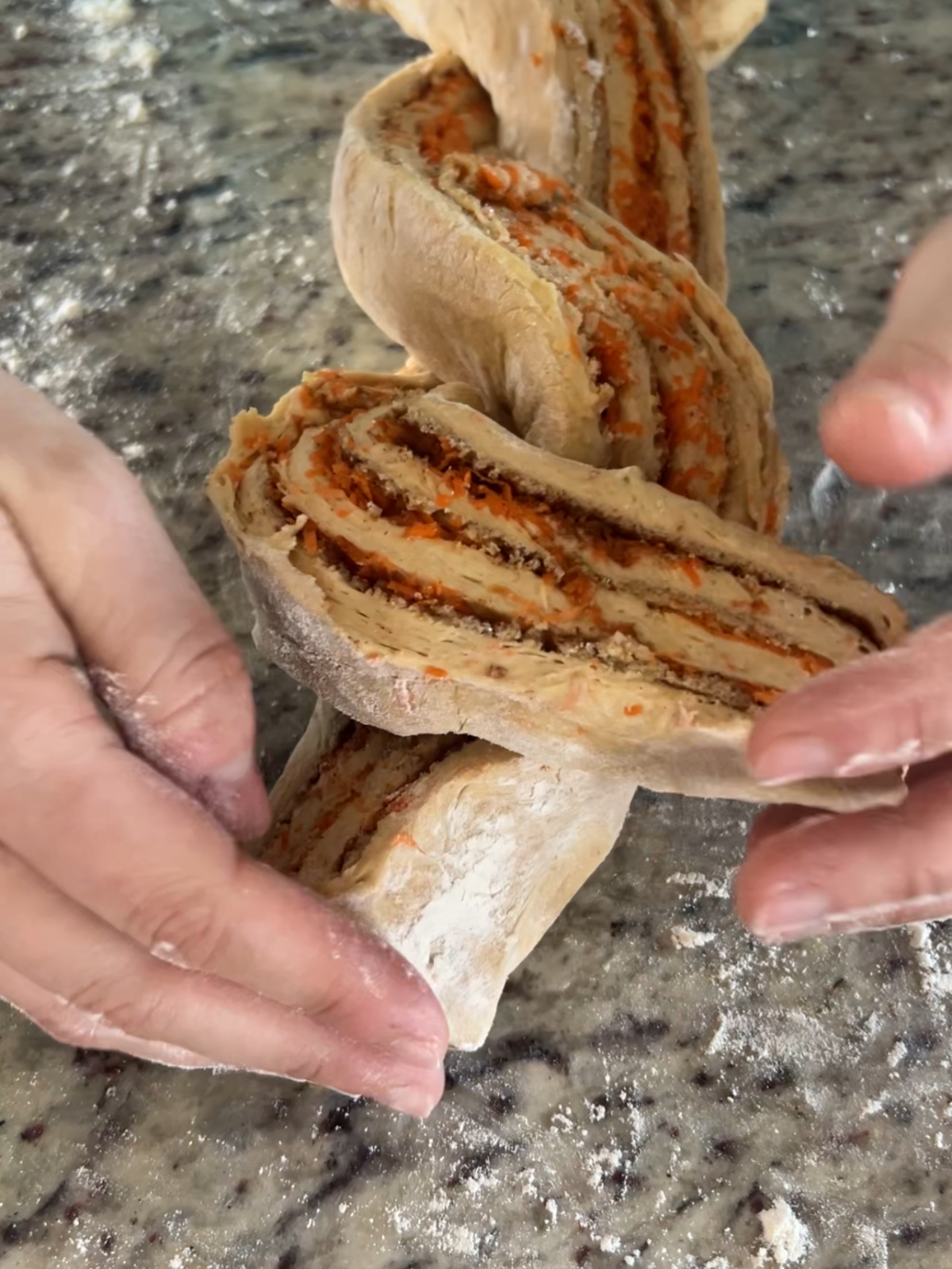 Showing the third step of braiding the sourdough carrot cake babka.