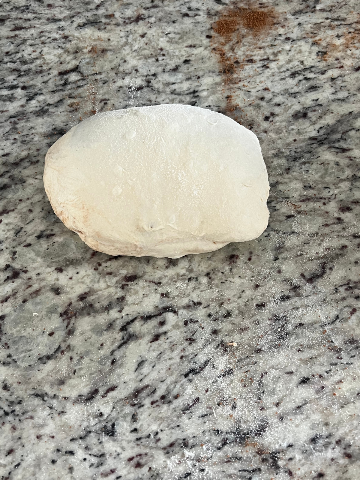 The dough has been rolled into a tight ball preparing for an overnight cold ferment.