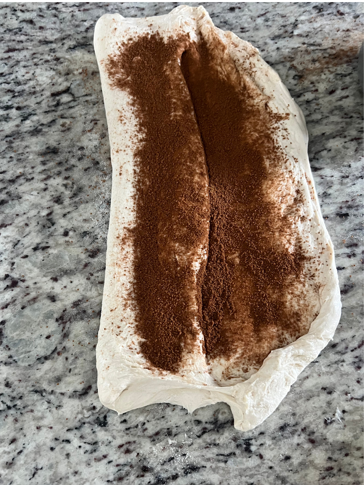 The dough has been tri-folded with the cinnamon sugar sprinkled over it.
