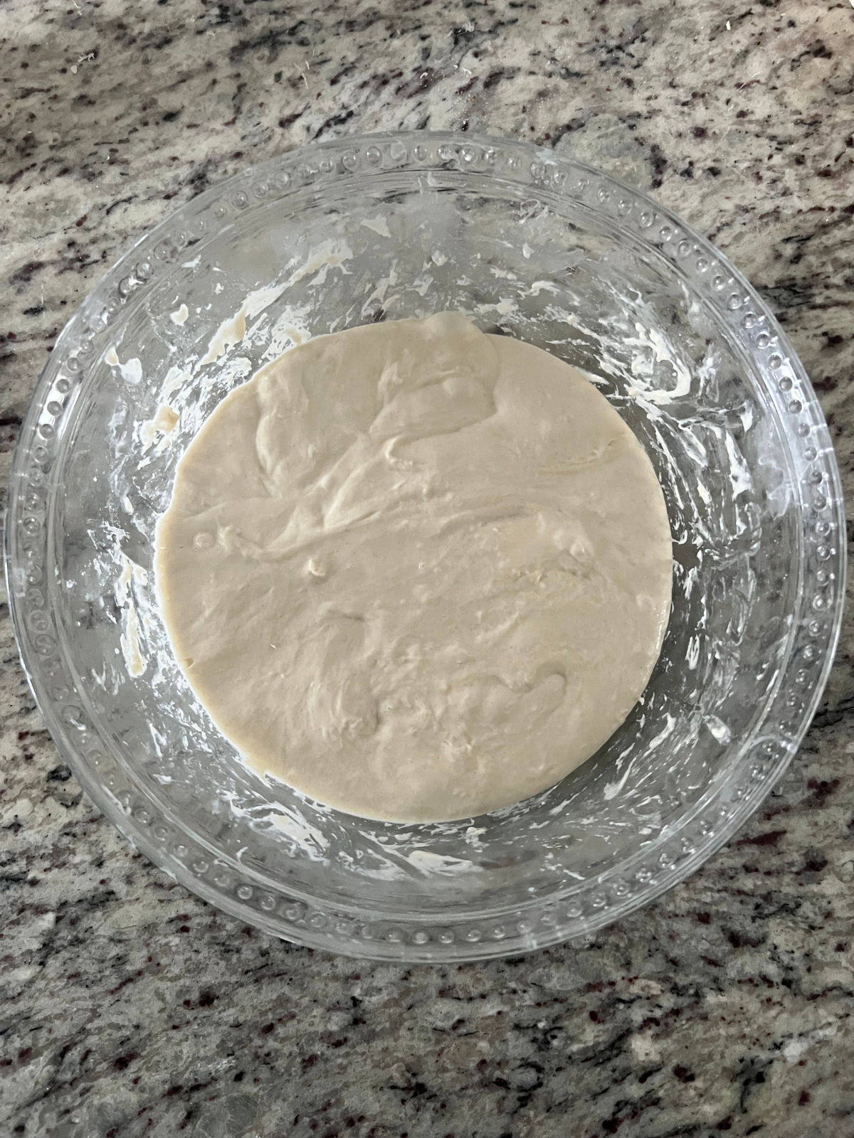 The sourdough focaccia dough is shown after a couple rounds of stretch and folds. It will now sit and complete bulk fermentation.