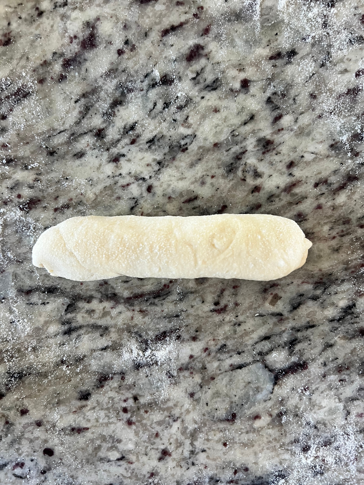 The sourdough hot dog bun dough is shaped and preparing for the second rise.
