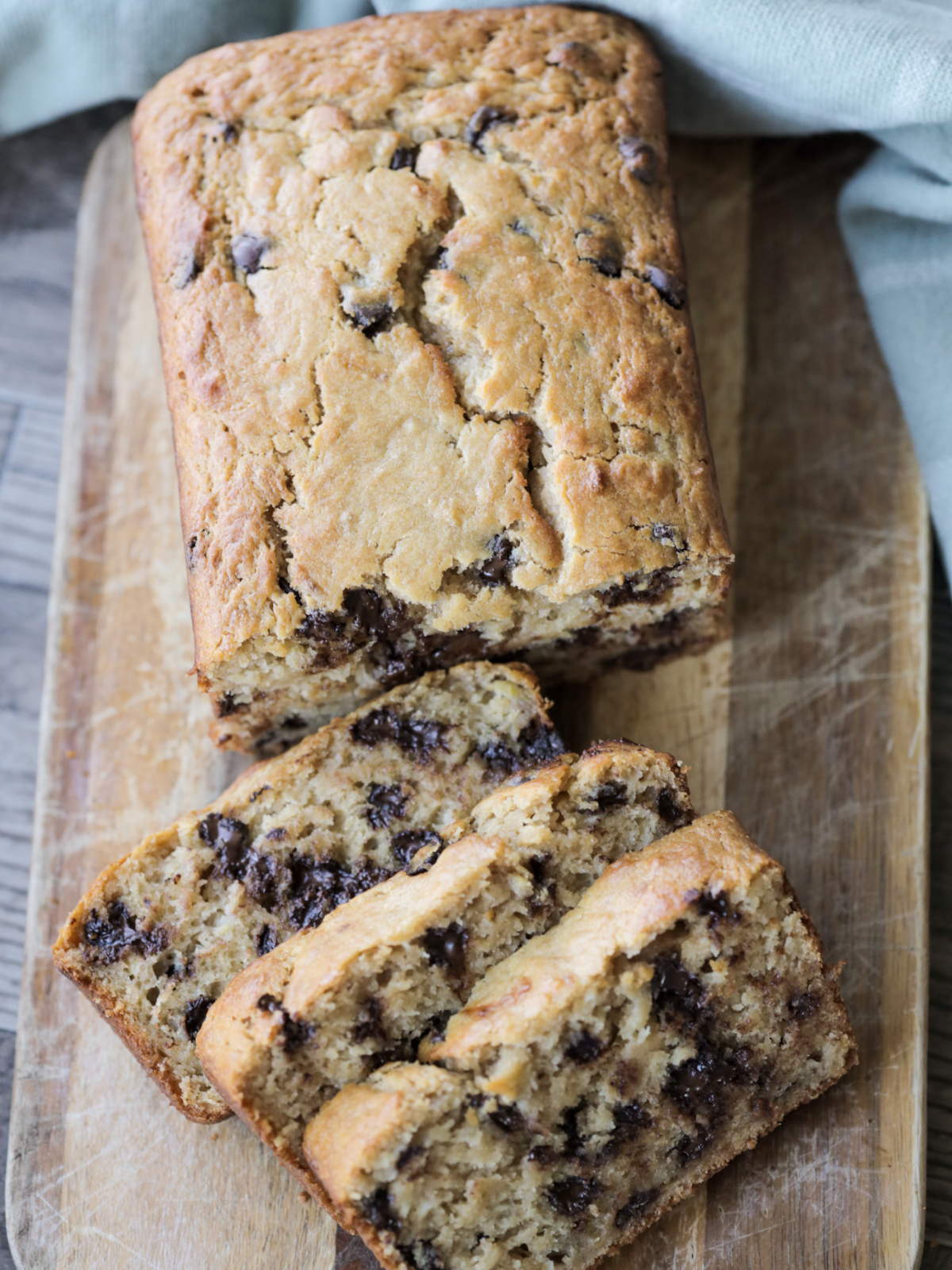 An overhead closeup is shown of the sourdough browned butter banana bread with three slices cut out. 
