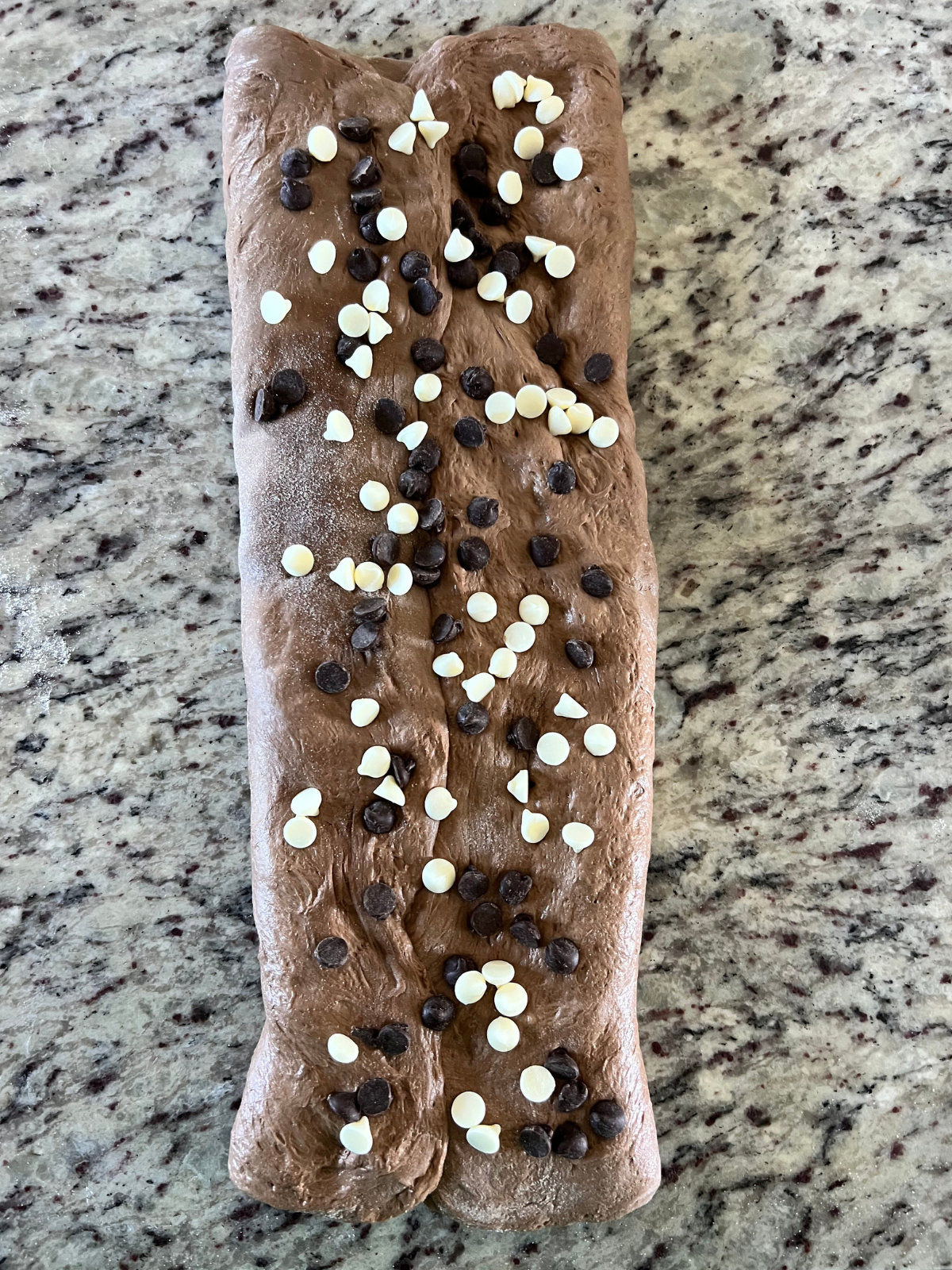 The dough has been letter folded and more chocolate chips has been spread over it.