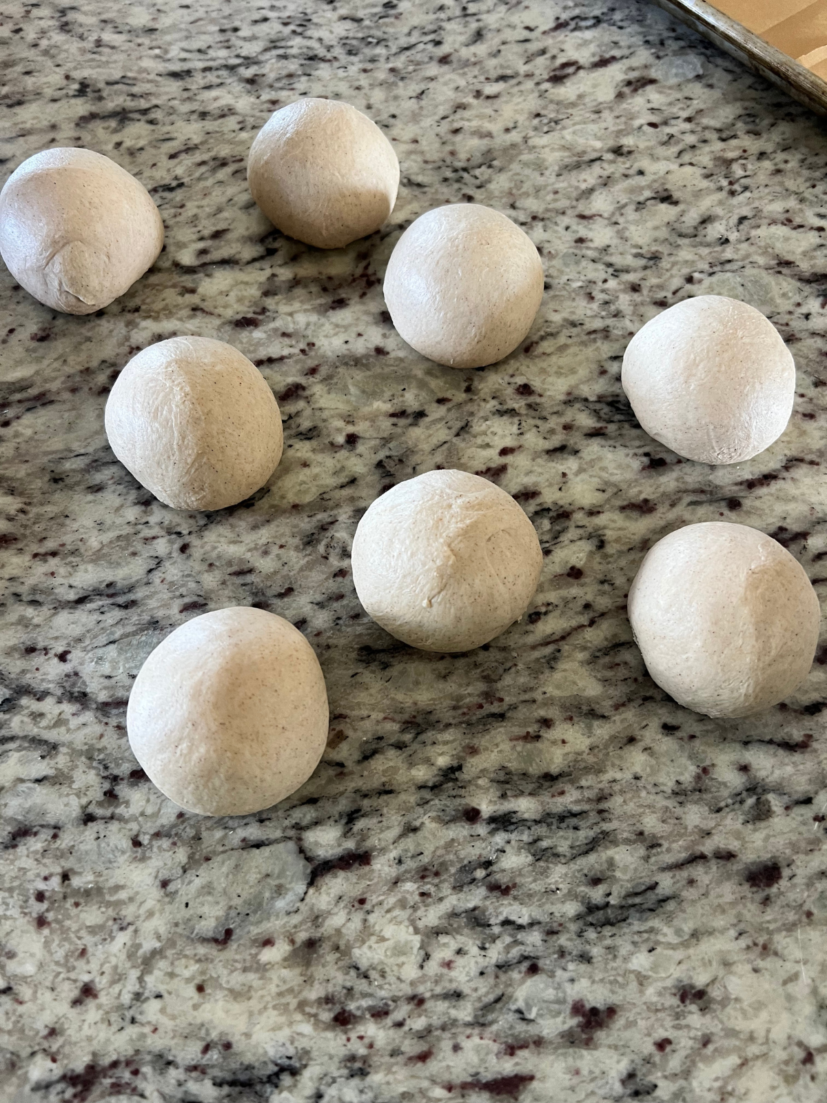 The sourdough cinnamon crunch dough balls sit on the counter as the gluten rests before shaping.