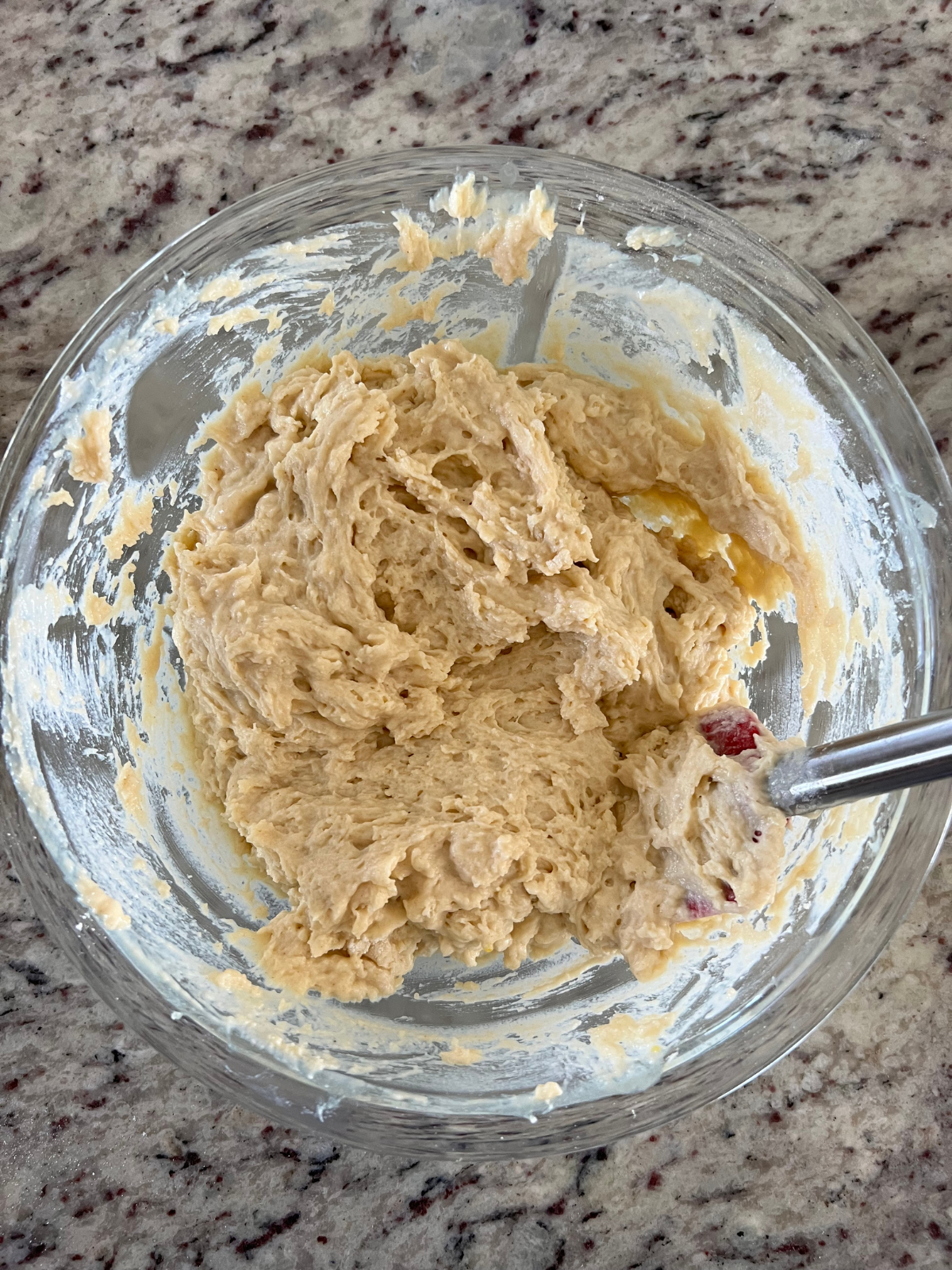 The sourdough coffee cake batter sits in a glass mixing bowl.