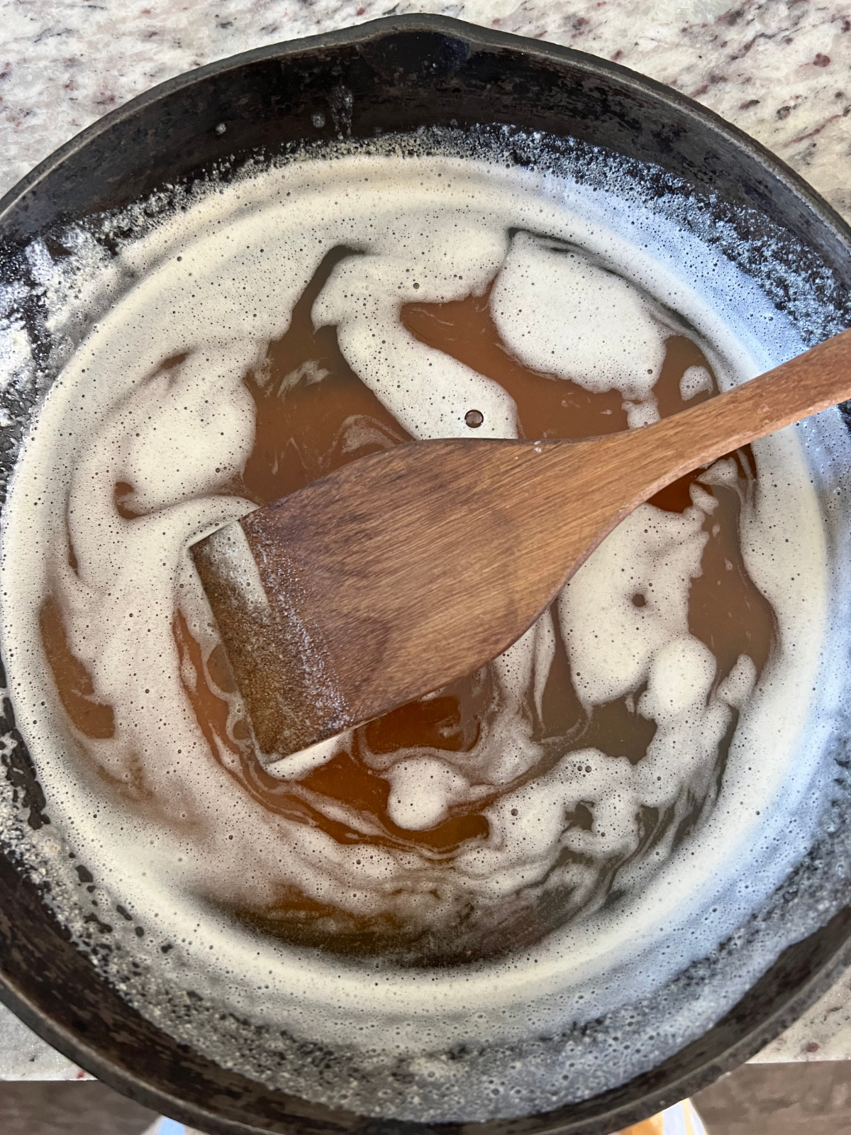 Browned butter is shown in a cast iron skillet.
