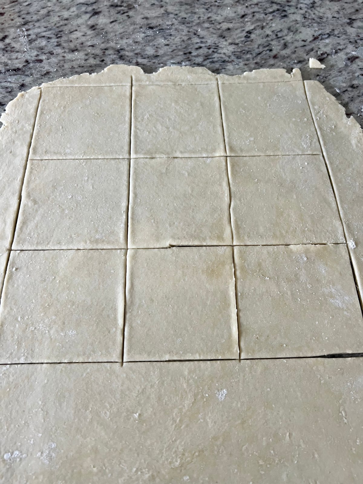 The sourdough hand pie crust is shown cut into 4x4" squares.
