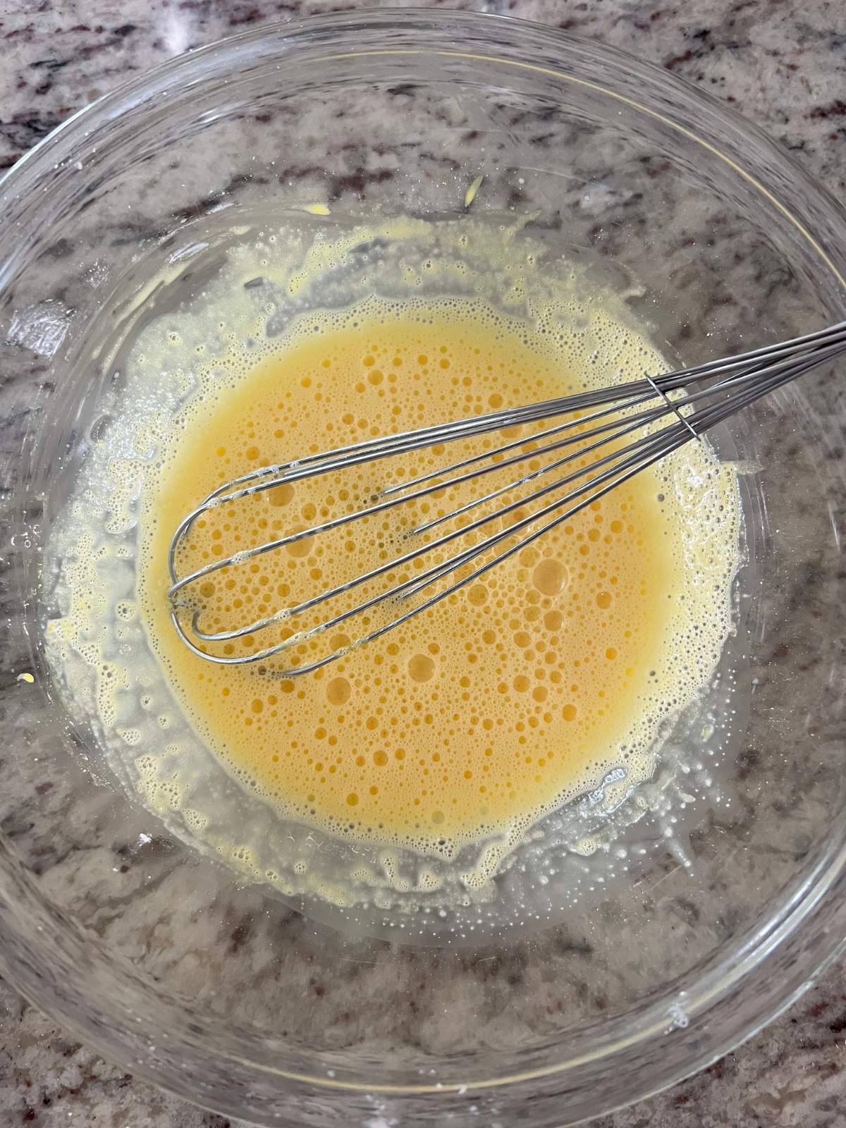 The egg yolks and cornstarch have been mixed. The hot milk will gradually be added to it.