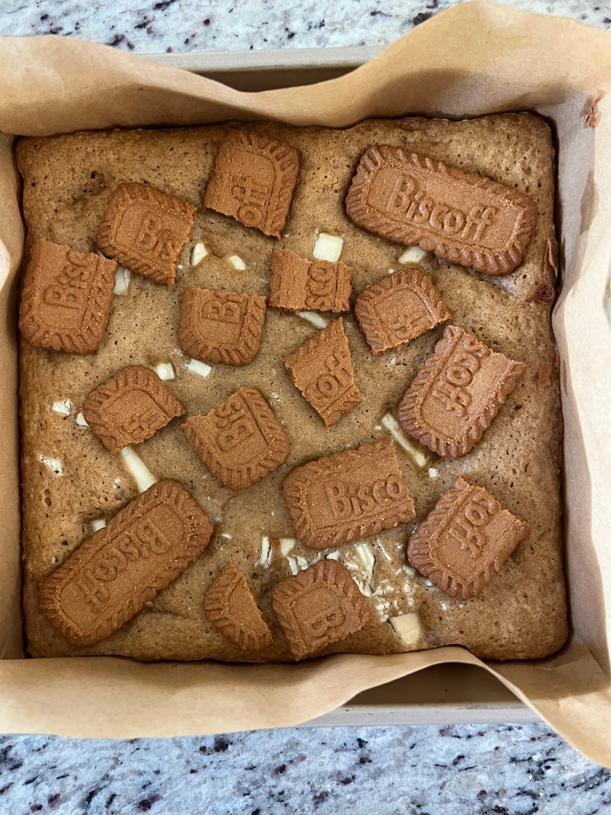 The Biscoff cookies are shown crumbled over the top of the sourdough discard blondies.