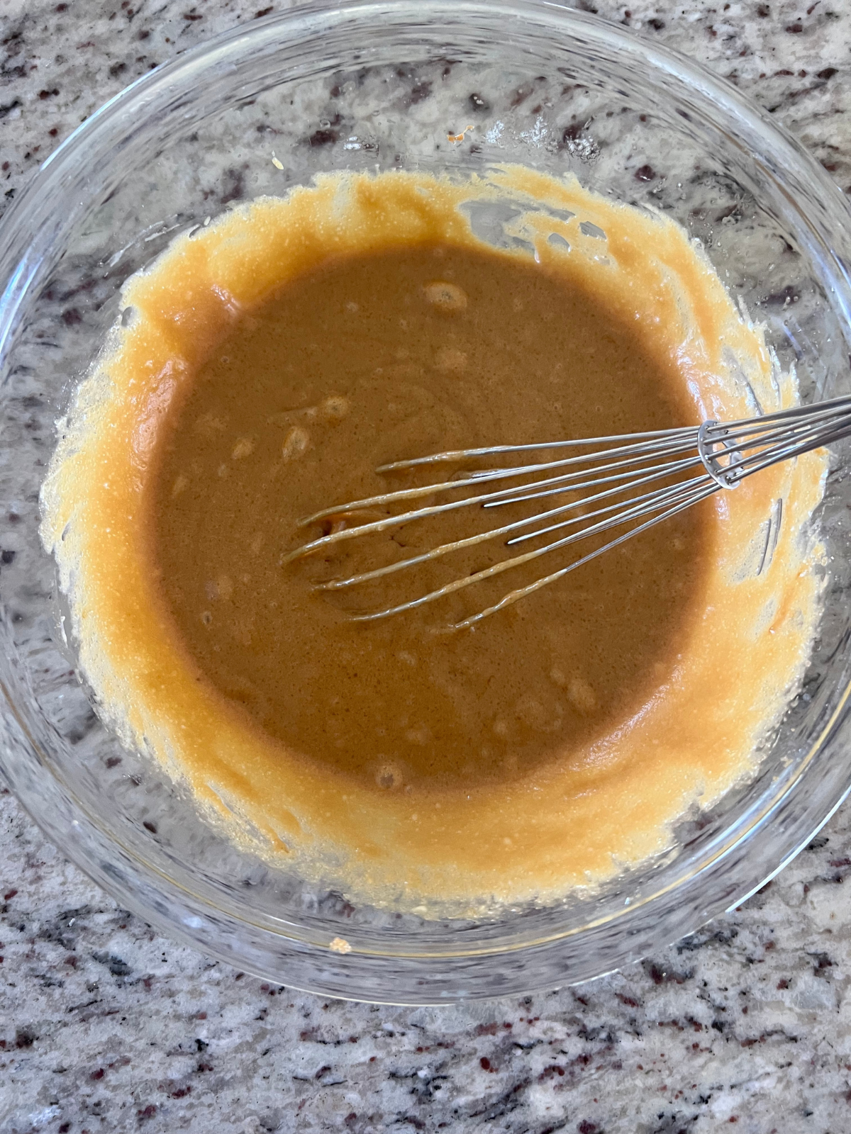 The wet ingredients for the sourdough discard biscoff blondies are shown in the glass mixing bowl.