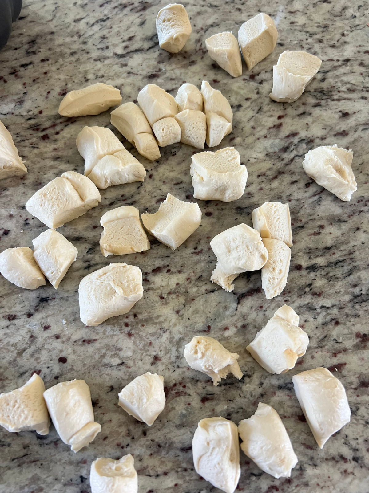 The sourdough monkey bread dough has been split into smaller pieces. 