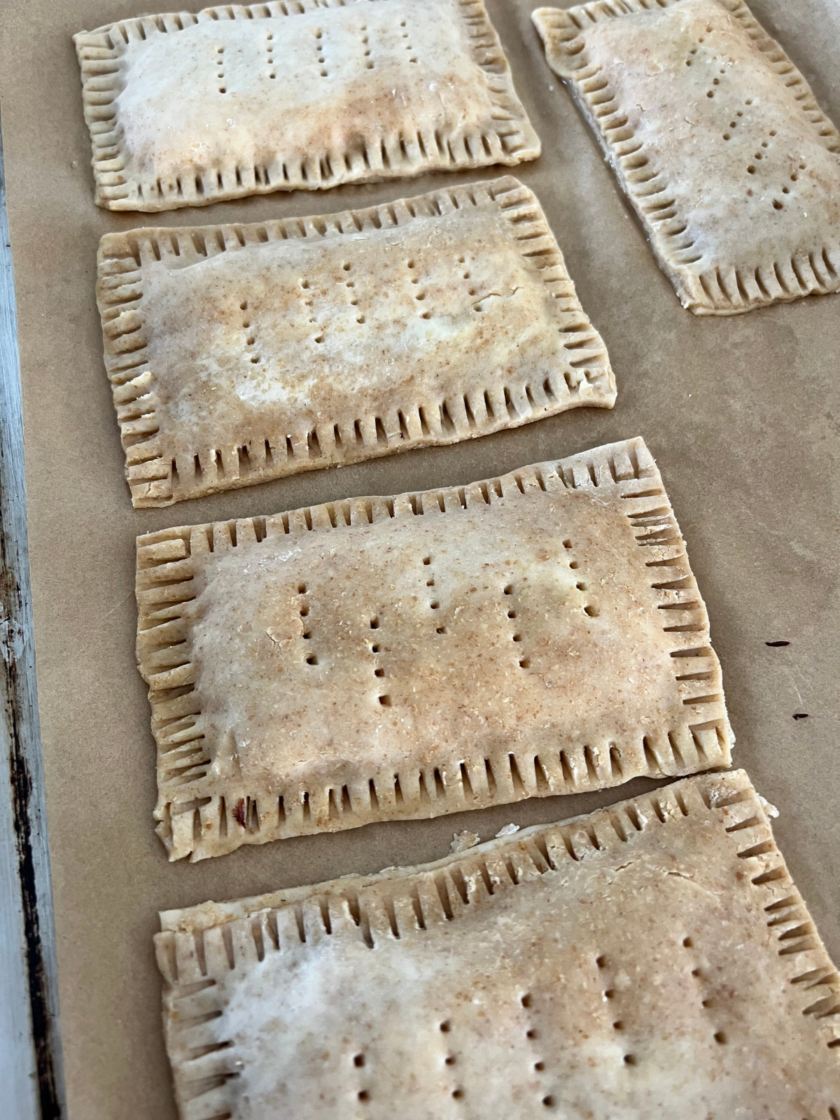 The assembled sourdough s'mores pop-tarts are shown on the baking sheet preparing to be baked.